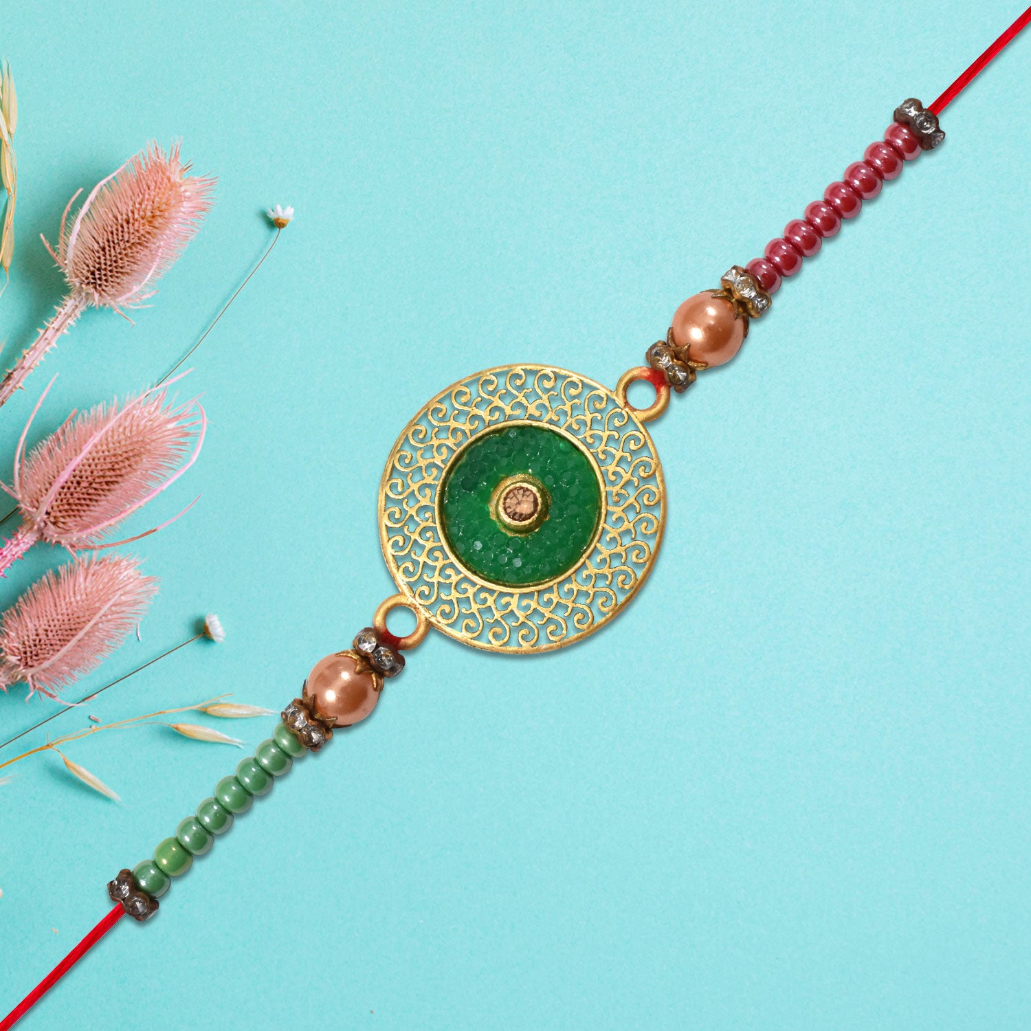 Elegant Green Circular Rakhi With Golden Filigree Design Elegant Green Circular Rakhi With Golden Filigree Design